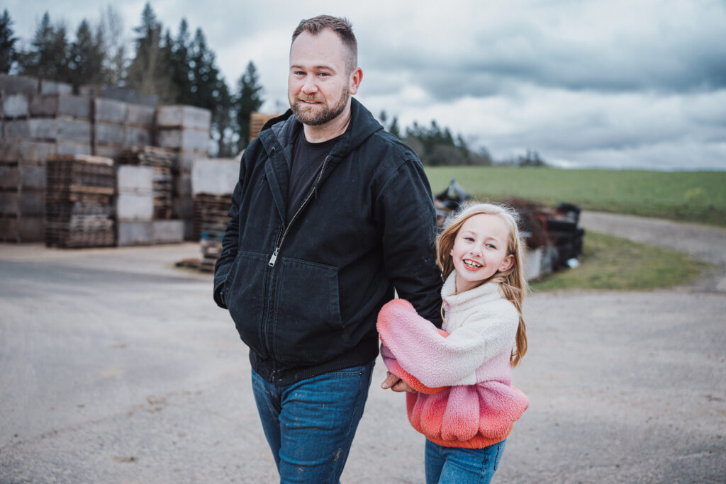 girl walking with her dad at their farm